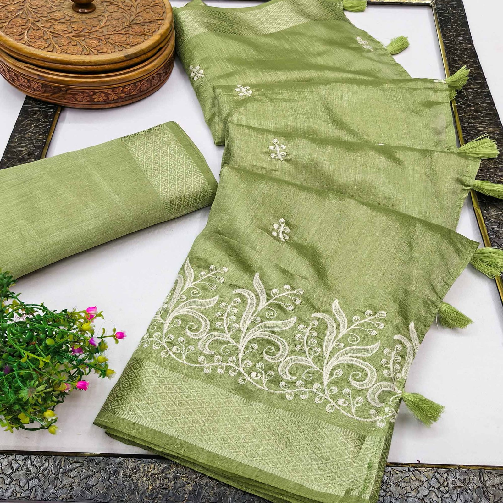 Green Art Silk Saree Adorned With Delicate Floral Embroidery & Stylish Tassel Pallu